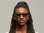 Model is wearing The DOLT CLIP LIMITED EDITION in size 46 in Gold with Blue Tinted Lenses