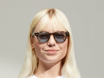 Model is wearing The DOLT CLIP LIMITED EDITION in size 46 in Gold with Blue Tinted Lenses