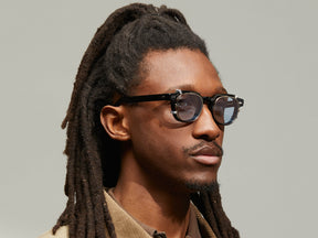 Model is wearing The DOLT CLIP in Gold in size 46 with Bel Air Blue Tinted Lenses