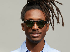 Model is wearing The DOLT CLIP in Gold in size 46 with G-15 Tinted Lenses