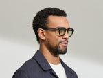 Model is wearing The DOLT in Dark Green in size 46 with GREEN+ Lenses