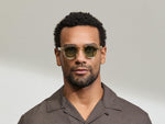 Model is wearing The DOLT in Flesh/Tortoise in size 46 with GREEN+ Lenses