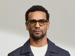 Model is wearing The DOLT in Grey-Brown Fade in size 46 with GREEN+ Lenses