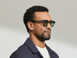 Model is wearing The DOLT in Grey-Brown Fade in size 46 with GREEN+ Lenses
