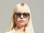Model is wearing The DOLT SUN Limited Edition in size 46 in Bark with Blue Tinted Lenses