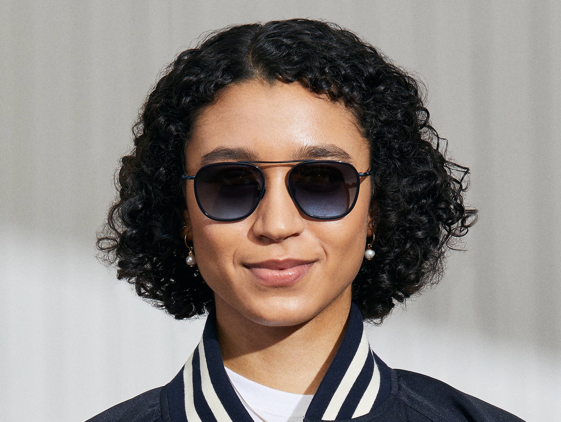 Model is wearing The FANAGLE SUN in Navy in size 53 with Denim Blue Tinted Lenses