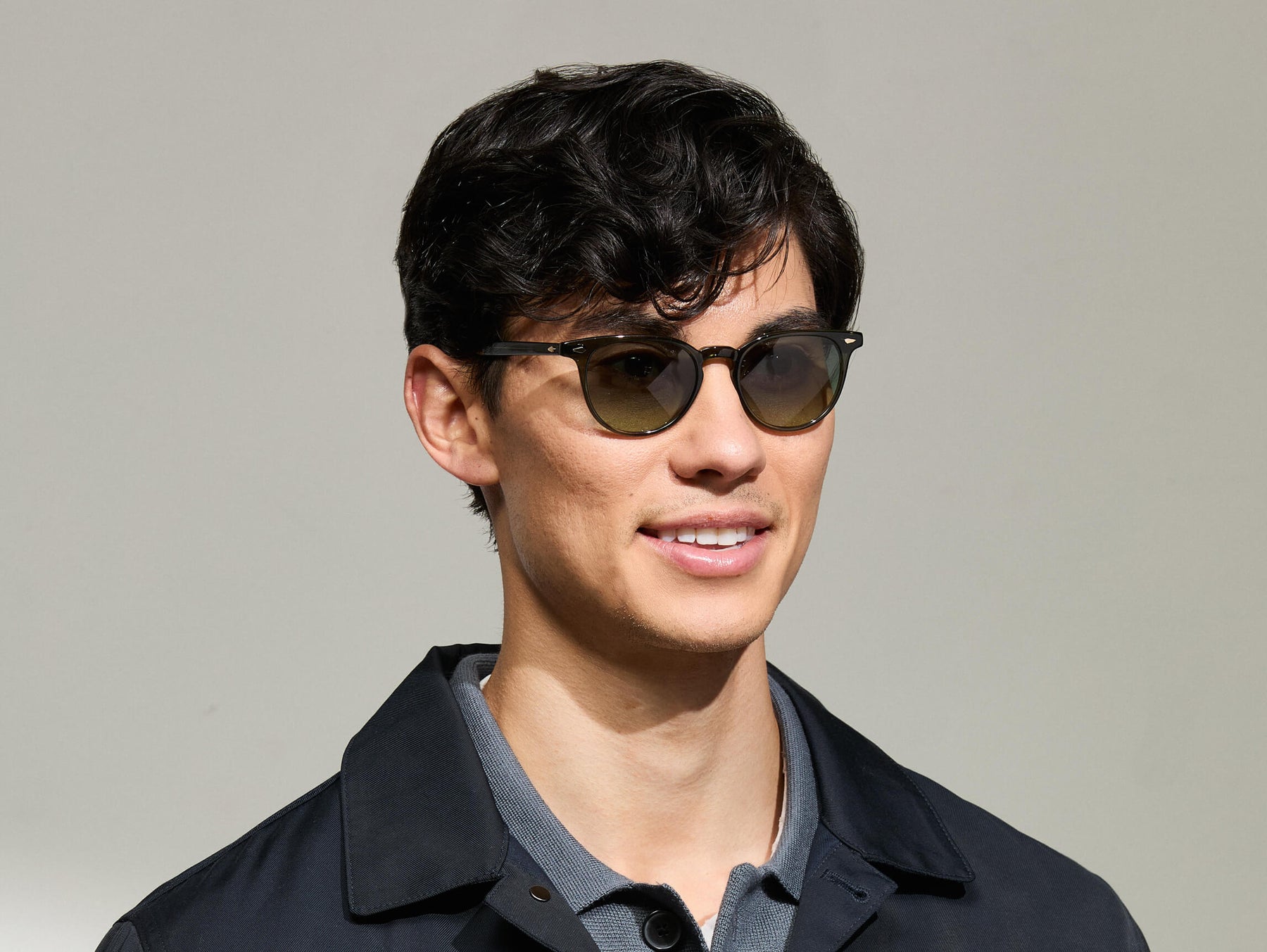 Model is wearing The FEVEL SUN in Dark Green in size 49 with Forest Wood Tinted Lenses