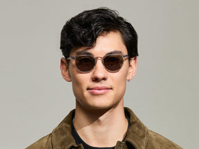 Model is wearing The FEVEL SUN in Light Grey in size 49 with G-15 Tinted Lenses