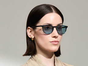 Model is wearing The FRANKIE SUN in Ink in size 51 with Mineral Blue Tinted Lenses