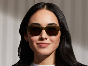 Model is wearing The GATKES SUN in Pine in size 49 with Green Lenses