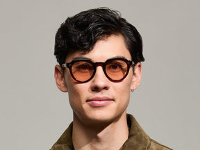 Model is wearing The GAVOLT SUN in Burgundy in size 48 with New York Rose Tinted Lenses