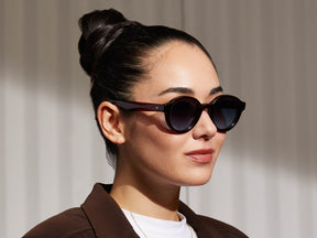 Model is wearing The GREPS SUN in Burgundy in size 47 with Denim Blue Tinted Lenses