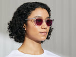 Model is wearing The GROBER in Crystal in size 48 with Purple Nurple Tinted Lenses