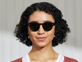 Model is wearing The GRUNYA SUN in Dark Green in size 47 with Calibar Green Glass Lenses