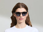 Model is wearing The GRUNYA SUN in size 47 in Black with Denim Blue Tinted Lenses