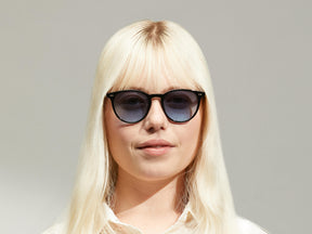 Model is wearing The JARED SUN in size 50 in Black with Denim Blue Tinted Lenses