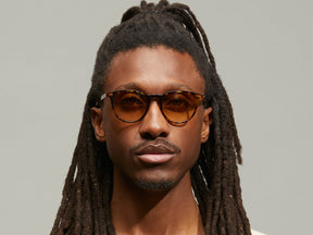 Model is wearing The JARED SUN in size 50 in Spot Tortoise with Chestnut Fade Tinted Lenses