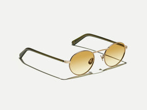 The KANAKA SUN in Gold/Dark Green with Chestnut Fade Tinted Lenses