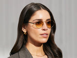 Model is wearing The KANAKA SUN in Gold/Dark Green in size 49 with Chestnut Fade Tinted Lenses
