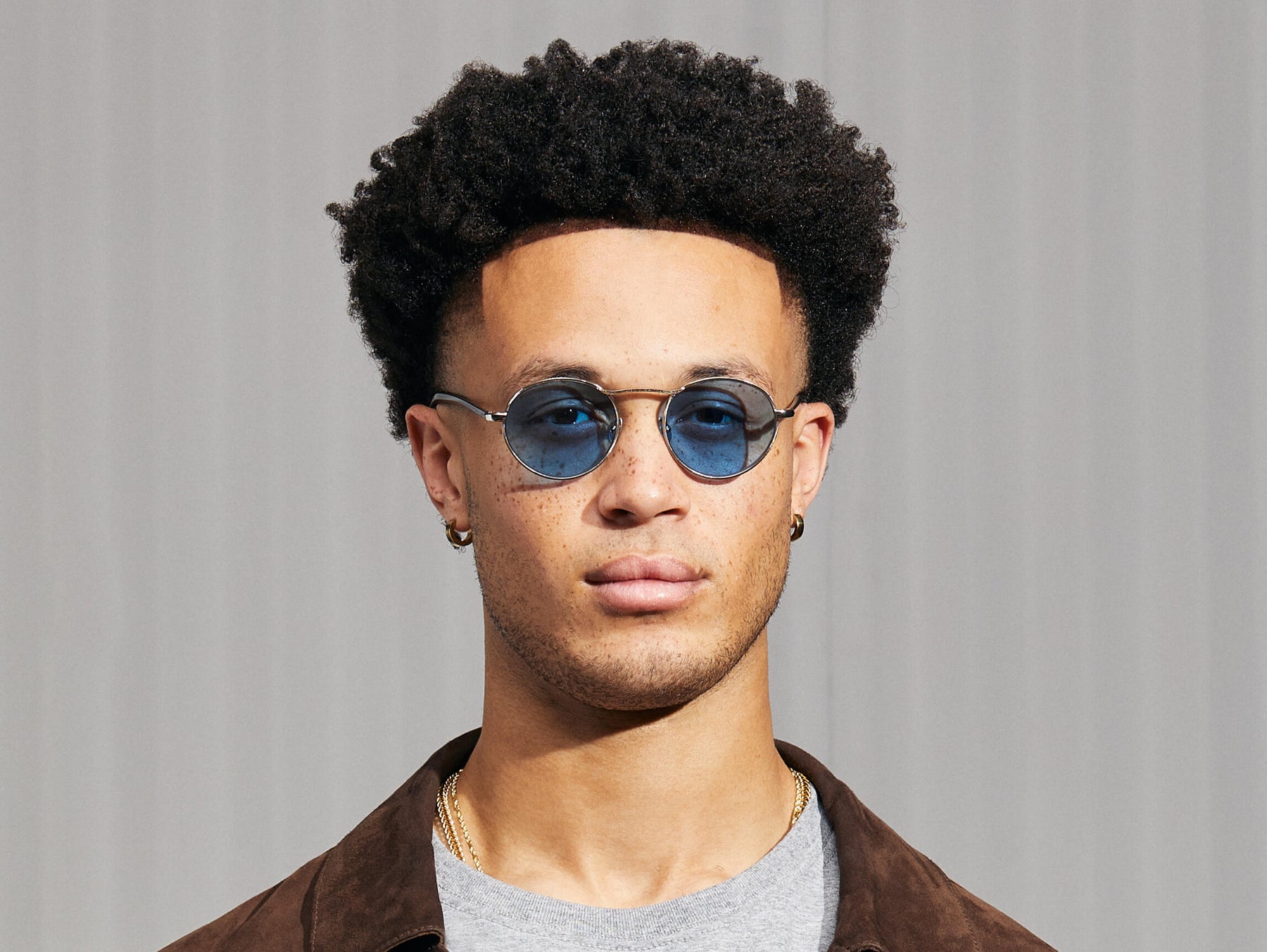 Model is wearing The KANAKA SUN in Silver/Ink in size 49 with Celebrity Blue Tinted Lenses