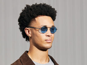 Model is wearing The KANAKA SUN in Silver/Ink in size 49 with Celebrity Blue Tinted Lenses