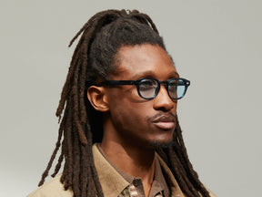 Model is wearing The LEMTOSH in Ink in size 46 with BLUE+ Tinted Lenses