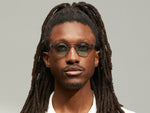 Model is wearing The LEMTOSH in Light Grey in size 46 with Turquoise Tinted Lenses