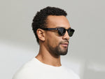 Model is wearing The LEMTOSH SUN-POLARIZED in size 46 in Black with G-15 Glass Polarized Lenses