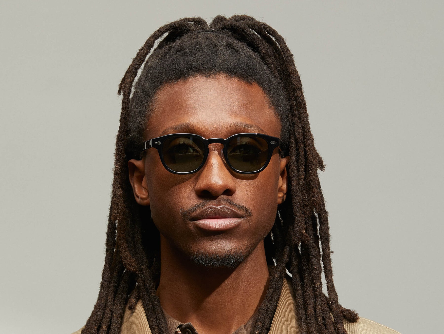 Model is wearing The LEMTOSH SUN with Metal Nose Pads in Black in size 46 with G-15 Glass Lenses
