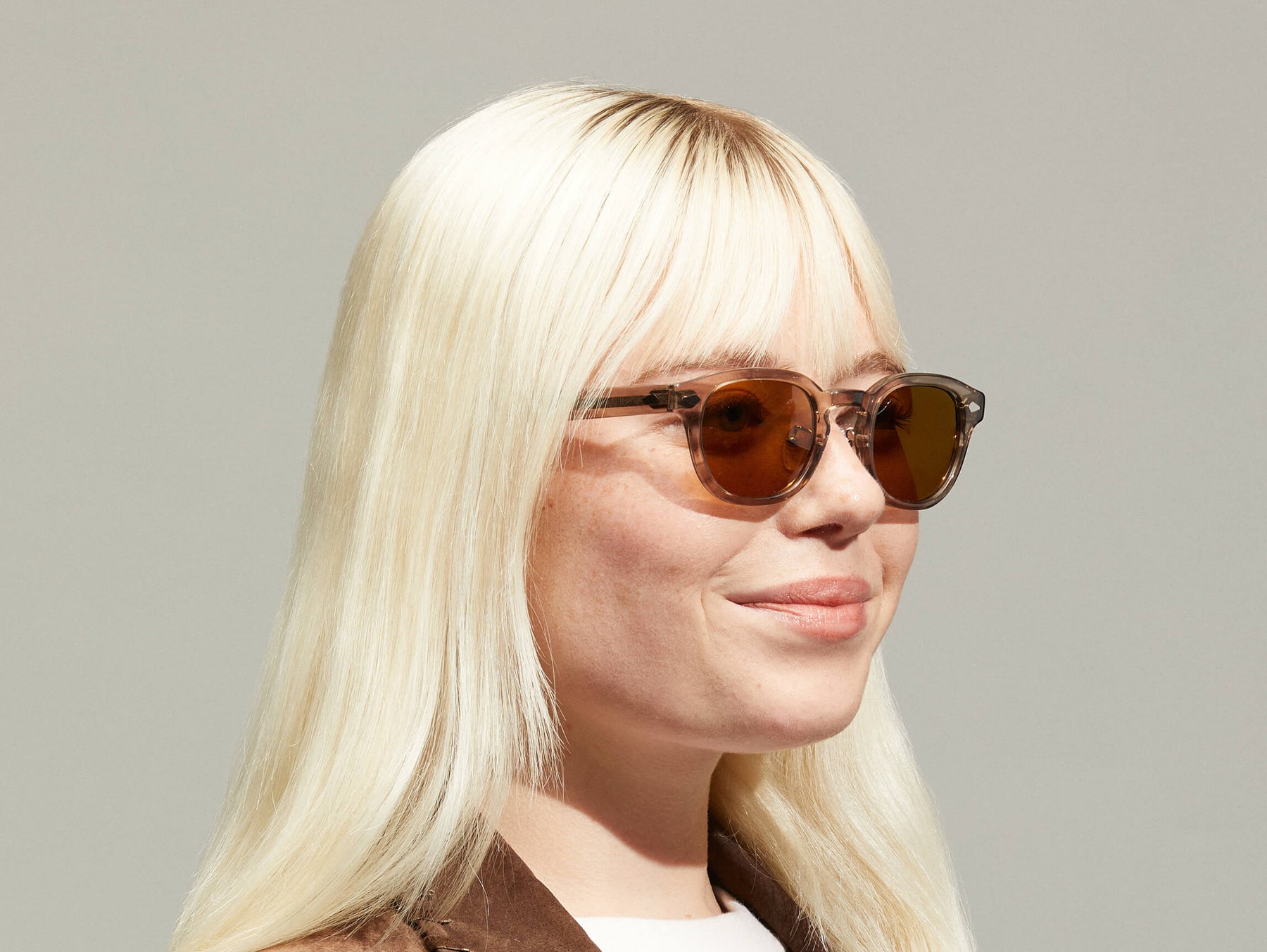 Model is wearing The LEMTOSH SUN with Metal Nose Pads in Brown Ash in size 46 with Cosmitan Brown Glass Lenses