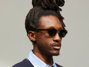 Model is wearing The LEMTOSH SUN with Metal Nose Pads in Tortoise in size 46 with G-15 Glass Lenses