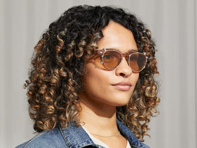 Model is wearing The MAYDELA CLIP in Gold in size 49 with Amber Tinted Lenses