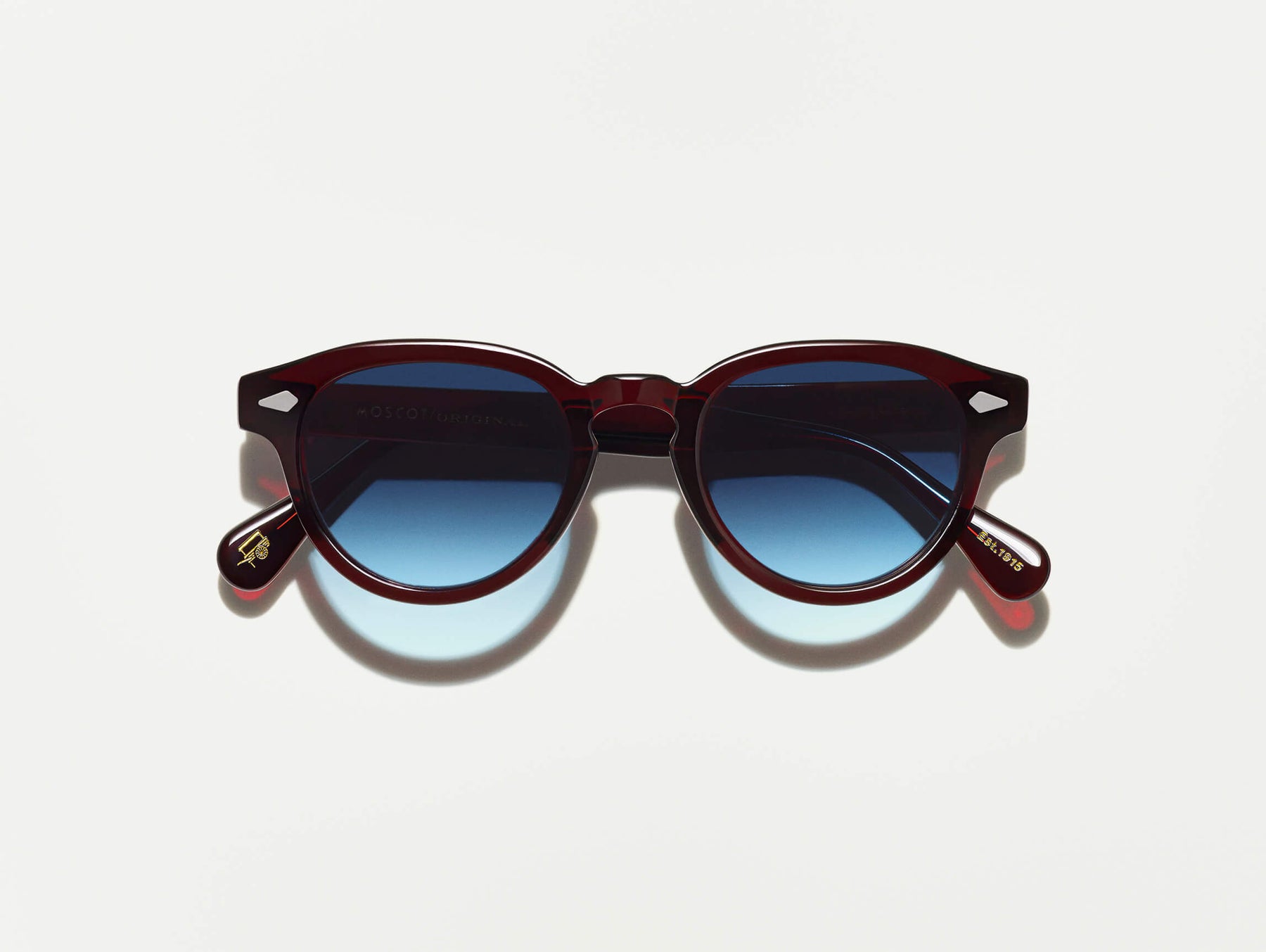 The MAYDELA SUN in Burgundy with Denim Blue Tinted Lenses