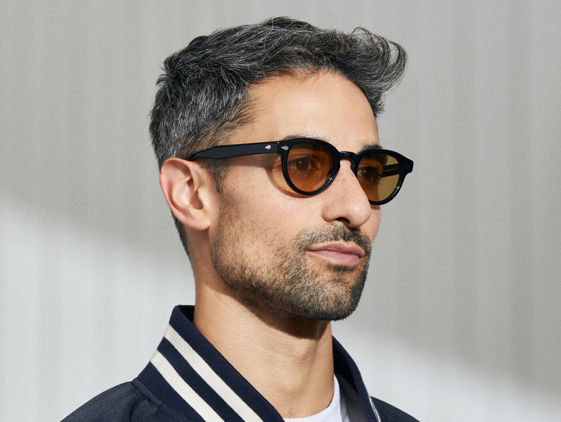 Model is wearing The MAYDELA SUN in Black in size 46 with Amber Tinted Lenses