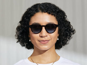 Model is wearing The MAYDELA SUN in Burgundy in size 49 with Denim Blue Tinted Lenses