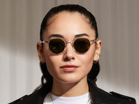 Model is wearing The MILTZEN SUN in Crystal in size 44 with G-15 Glass Lenses