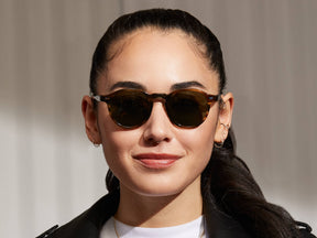 Model is wearing The MILTZEN SUN in Bark in size 44 with G-15 Glass Lenses