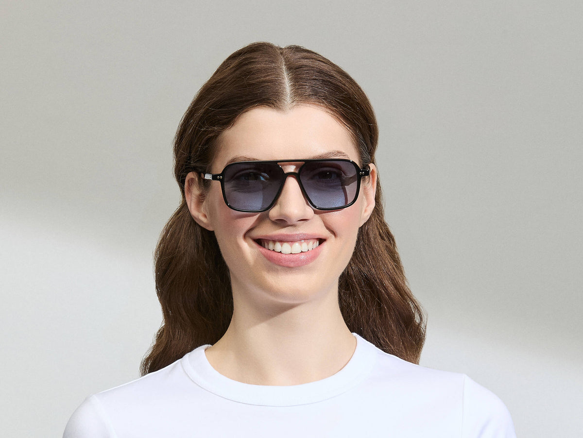 Model is wearing The MINYAN SUN in size 54 in Black with Denim Blue Tinted Lenses