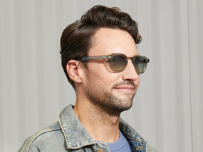 Model is wearing The MOMZA SUN in Sage in size 49 with Forest Wood Tinted Lenses