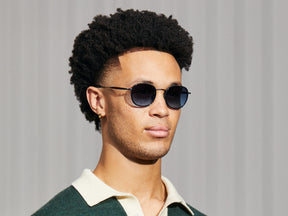 Model is wearing The MOSHA SUN in Navy/Navy in size 49 with Denim Blue Tinted Lenses