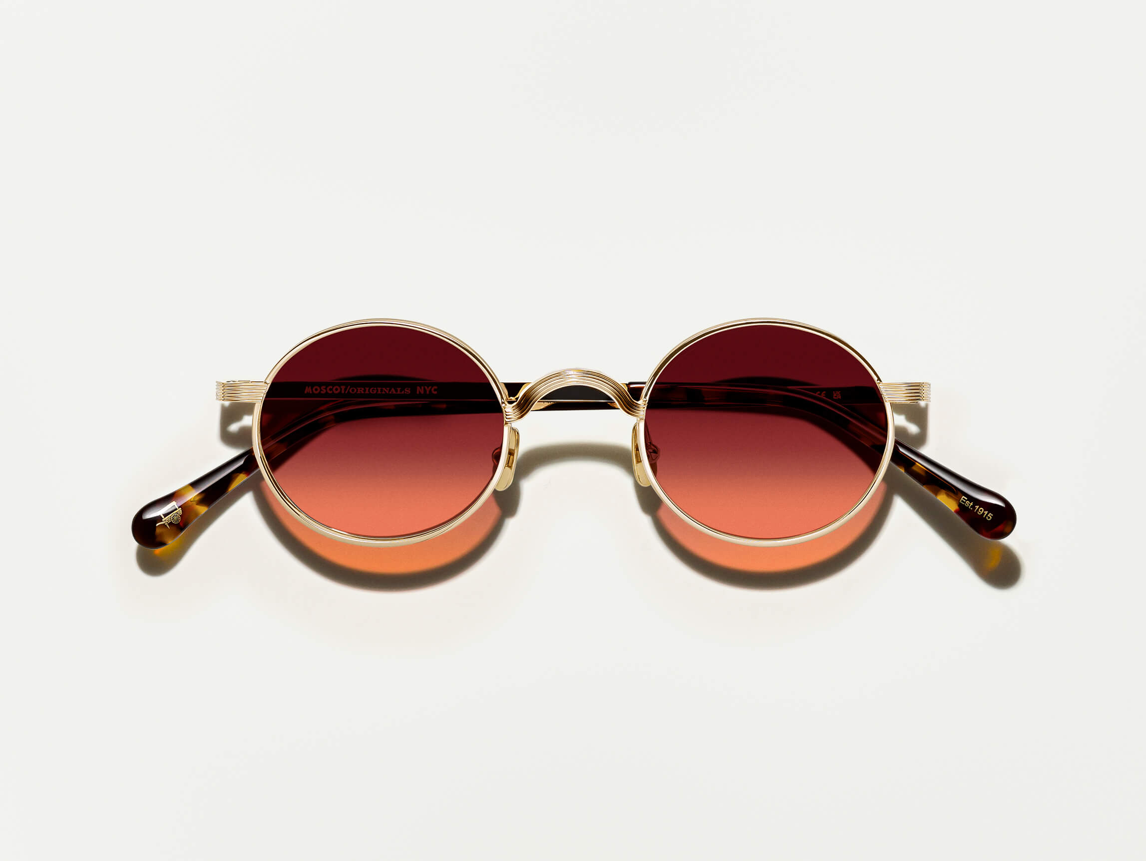The MOYEL in Gold with Cabernet Tinted Lenses