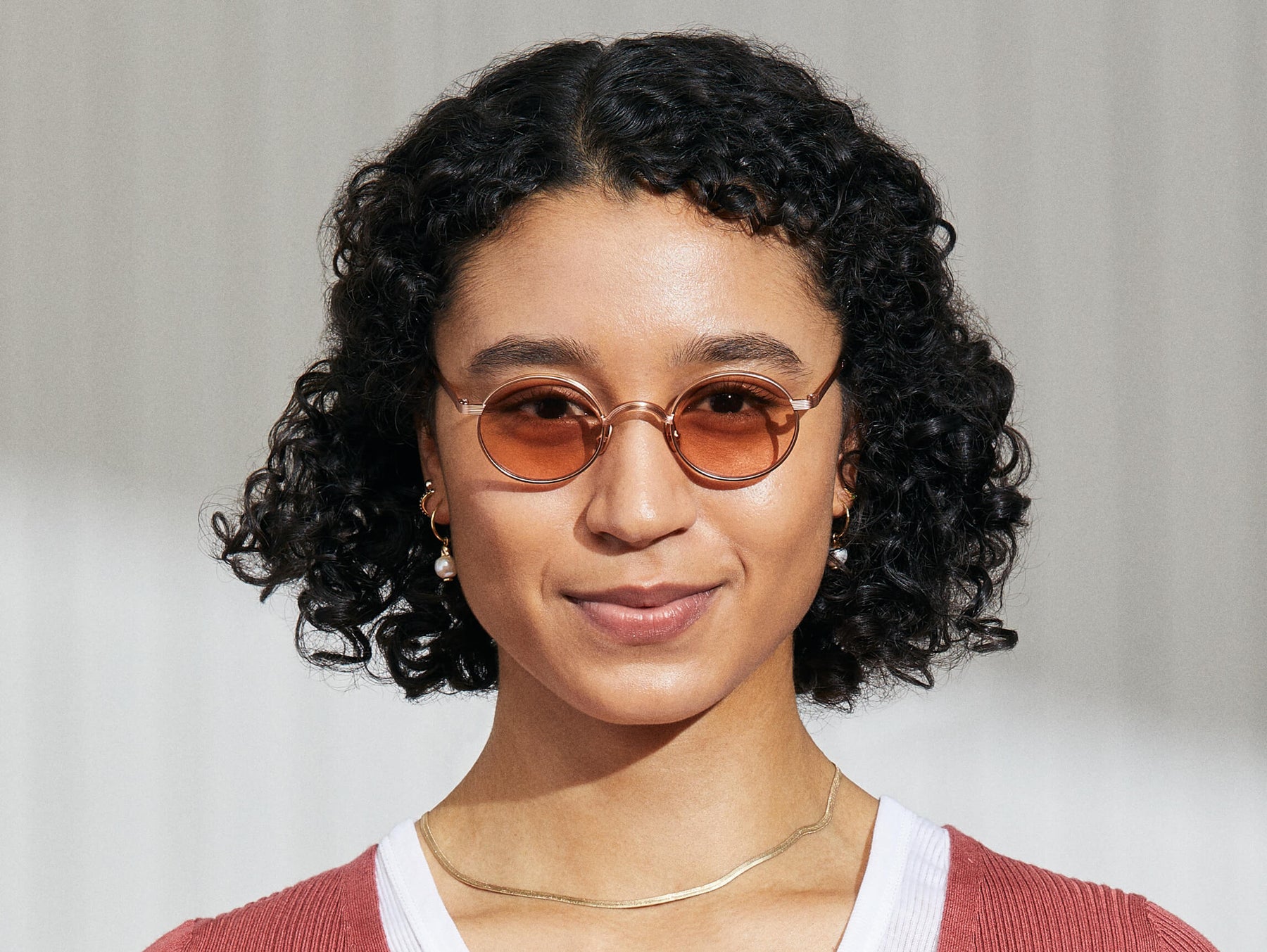 Model is wearing The MOYEL SUN in Rose in size 44 with New York Rose Tinted Lenses