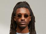 Model is wearing The MOYEL SUN in Gold in size 44 with G-15 Tinted Lenses