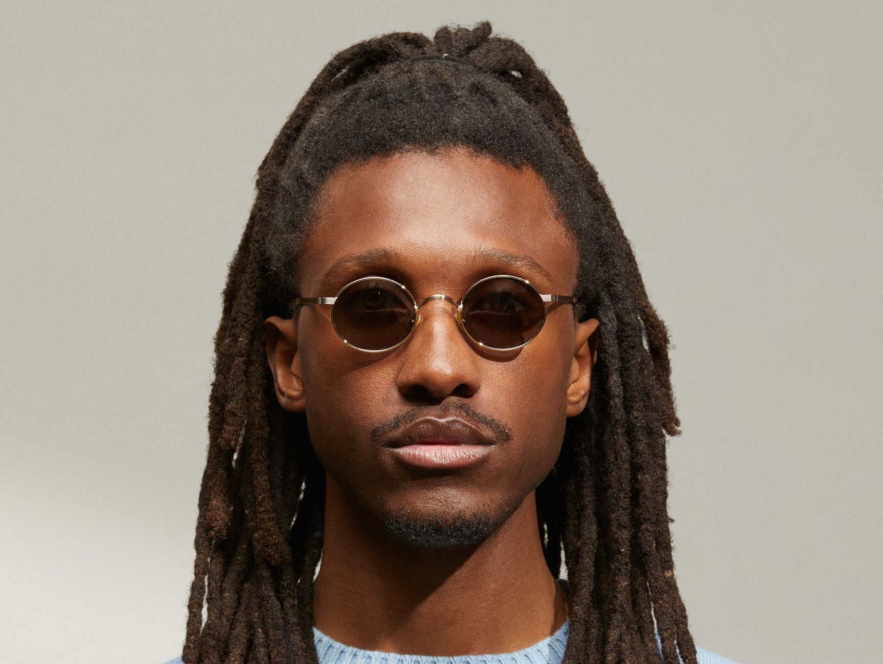 Model is wearing The MOYEL SUN in Gold in size 44 with G-15 Tinted Lenses