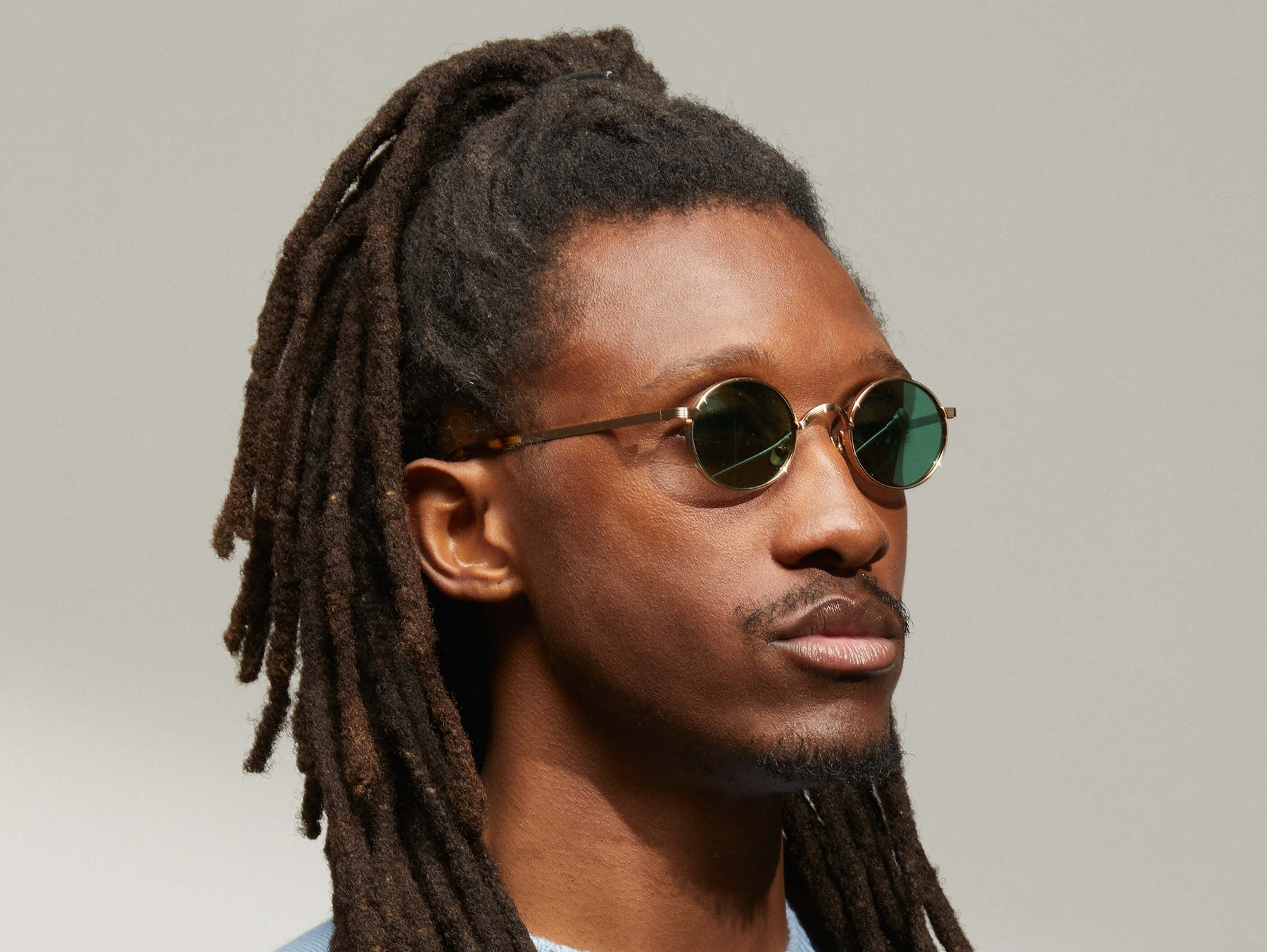 Model is wearing The MOYEL SUN in Gold in size 44 with G-15 Tinted Lenses