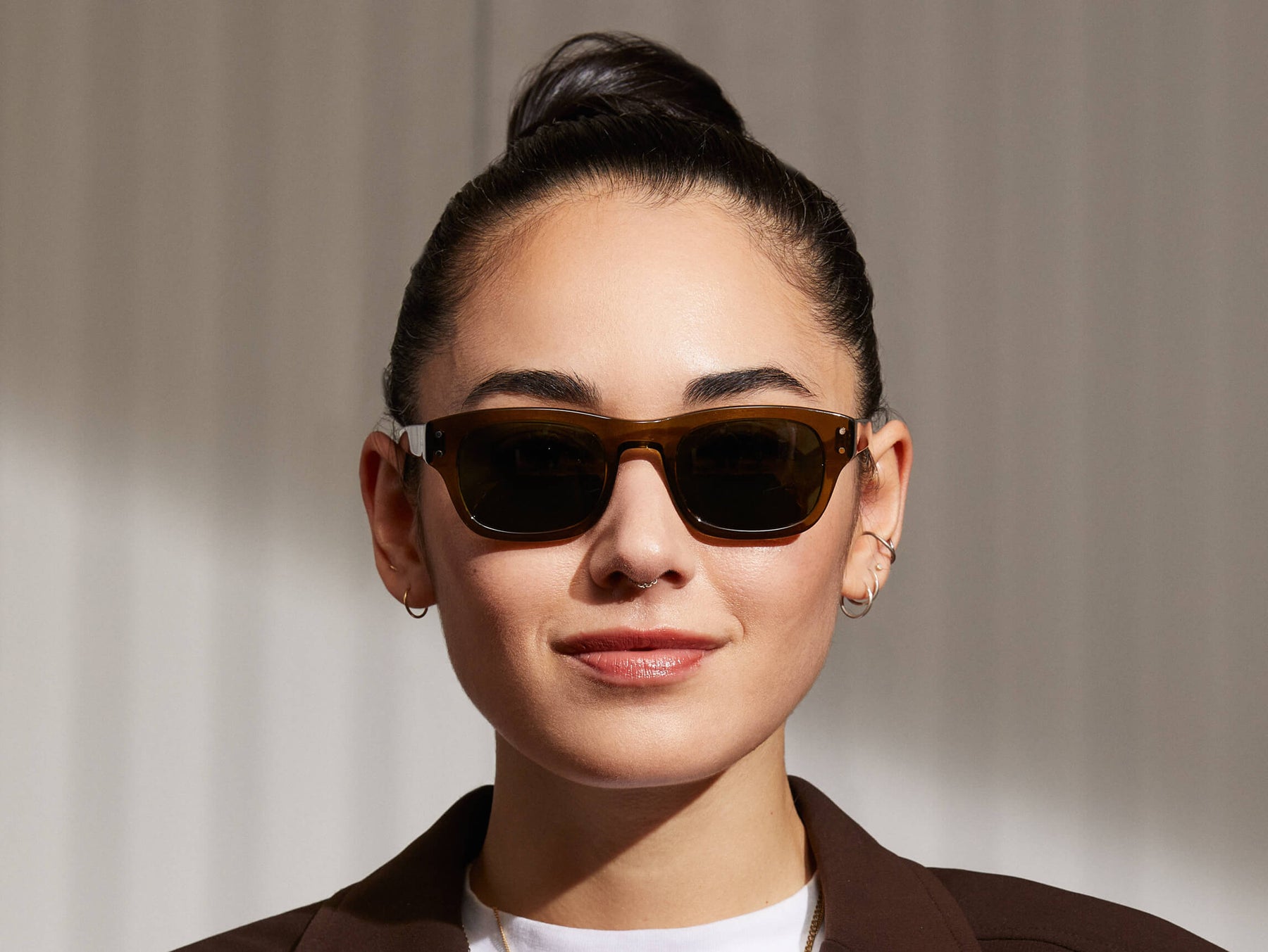 Model is wearing The NEBB SUN in Olive Green in size 48 with G-15 Glass Lenses
