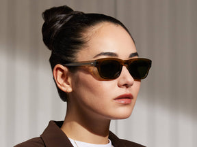Model is wearing The NEBB SUN in Olive Green in size 48 with G-15 Glass Lenses