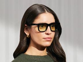 Model is wearing The RIZIK in Black in size 49 with Limelight Tinted Lenses