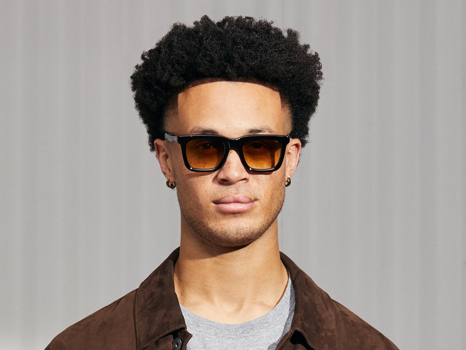 Model is wearing The RIZIK in Black in size 49 with Chestnut Fade Tinted Lenses