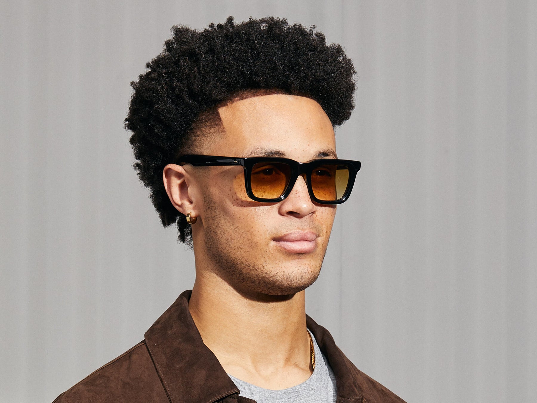 Model is wearing The RIZIK in Black in size 49 with Chestnut Fade Tinted Lenses